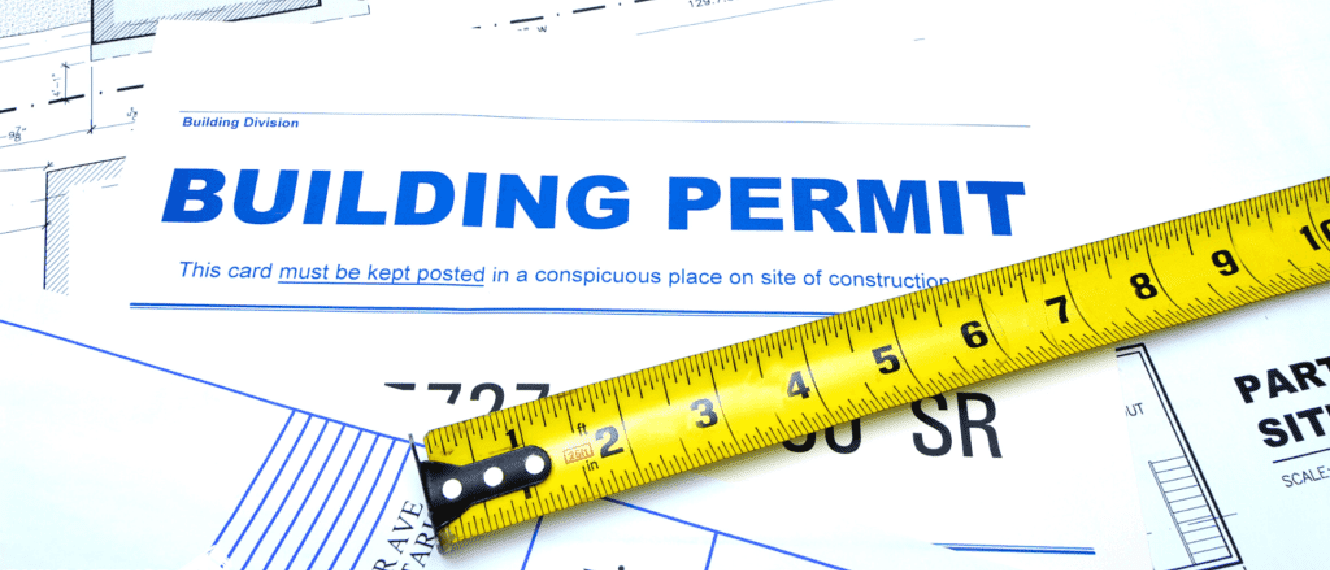 Building Permit document and tape measurer